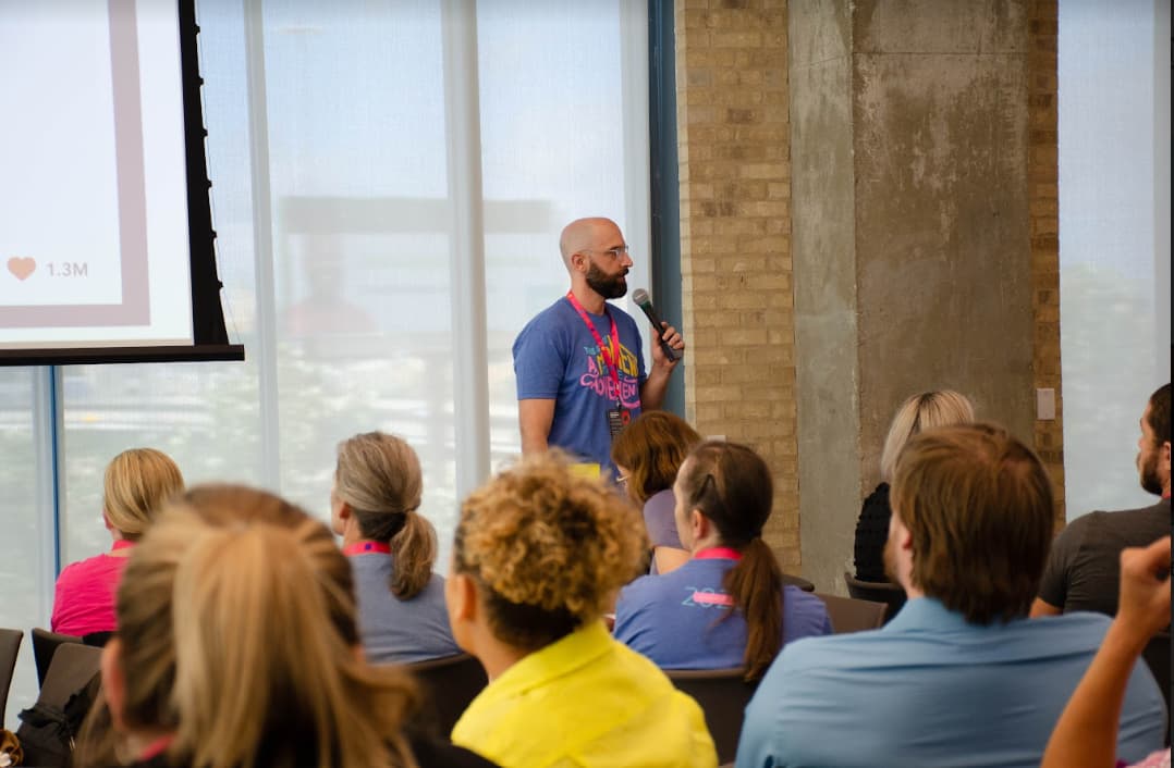 Adam Tank speaking to an audience at an industry event